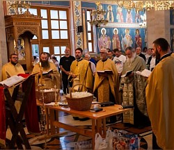 Priest Dejan Vojisavljević performs the act of anointing the faithful with holy oil for health and salvation under the dome of the church.