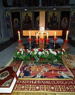 Priest Dejan Vojisavljevic carries the shroud during the evening service on Good Friday