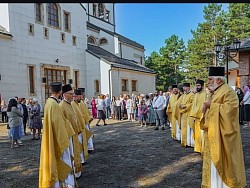 A panoramic shot of the church's gate full of people during the bishop's divine service, showing the unity of the church and the faithful who celebrate the Transfiguration of the Lord in common prayer in the mountain air