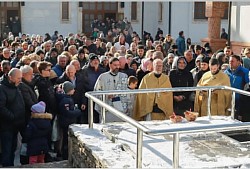 Priest Dejan Vojisavljević in the act of blessing water on the Epiphany