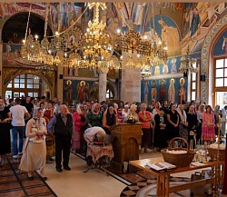 The interior of the church filled with believers during Sunday liturgy