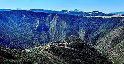 Dark green velvety carpet of moss on the southern side of a humid forest bay High tension of silence on the mountaintop where only one's own breath can be heard Layers of dry branches and leaves carried by a mountain torrent along the fir trees The glimmer of a mountain spring overflowing over the edge of a wooden water trough Traces of plowing and ploughing on a steep field descending straight towards the canyon The soft texture of juniper pads emerging from the dry Zlatibor karst - A group of tall pine trees protruding above the fog like the masts of a sunken ship Stone slabs covered with lichens that form natural steps on the slope The sun refracting through a thick rain curtain, creating a rainbow over Murtenica The scent of damp earth and rotting leaves in the deep cuts of Zlatibor forests Low blueberry bushes that take on the color of dark wine in autumn A narrow gorge through which the wind constantly blows howls creating mountain music