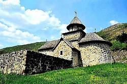 Morning mist slowly lifting from the pastures revealing mountain peaks Sharp mountain ridges covered with deep snow and ice during the winter months Narrow rocky paths leading to hidden Zlatibor viewpoints A forest spring gushing from under the roots of an old pine surrounded by cool moss A scene of untouched wilderness where only the sound of the wind and birds of prey can be heard Frost-laden pine branches shimmering in the bright mountain sun